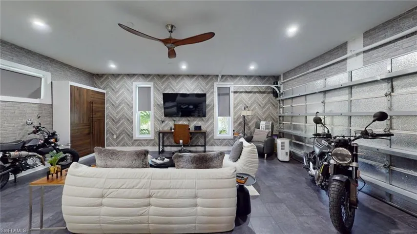 Living area featuring ceiling fan, a garage, and recessed lighting
