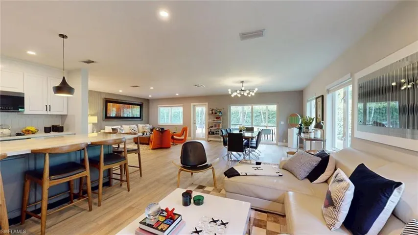 Living area featuring recessed lighting, a notable chandelier, light wood finished floors, and visible vents