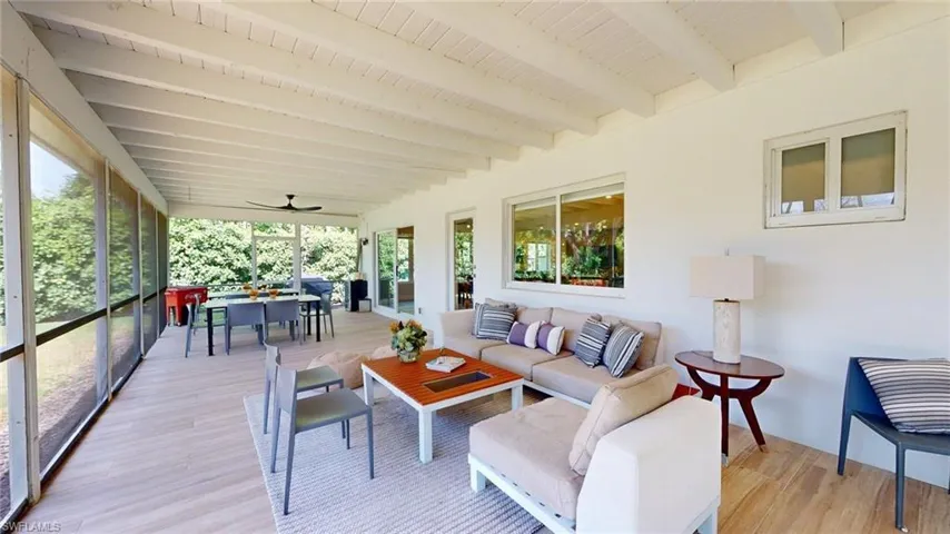 Sunroom featuring an outdoor hangout area, outdoor dining space, a healthy amount of sunlight, and beam ceiling