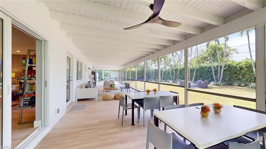 Sunroom / solarium with beam ceiling, wood finished floors, outdoor dining space, a ceiling fan, and wood ceiling