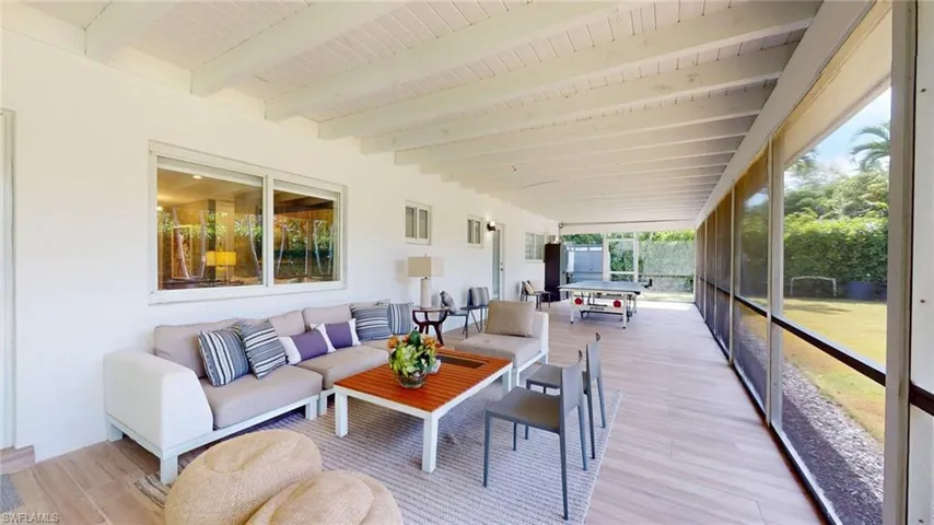 Sunroom / solarium featuring outdoor lounge area and beamed ceiling