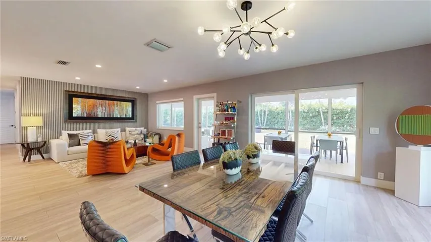 Dining room featuring recessed lighting, a notable chandelier, light wood finished floors, and visible vents