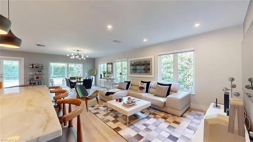 Living area featuring a chandelier, a wealth of natural light, and recessed lighting