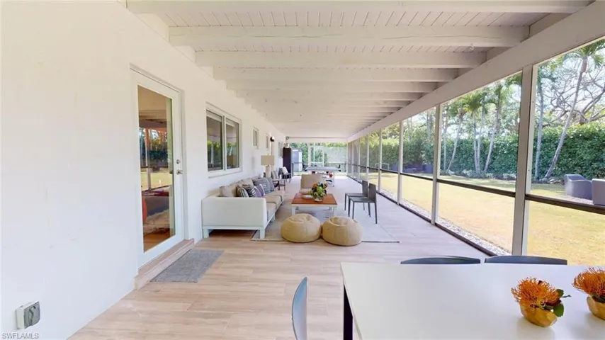 Sunroom featuring beamed ceiling