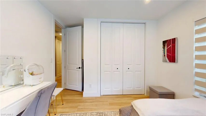 Bedroom with light wood-style floors and a closet