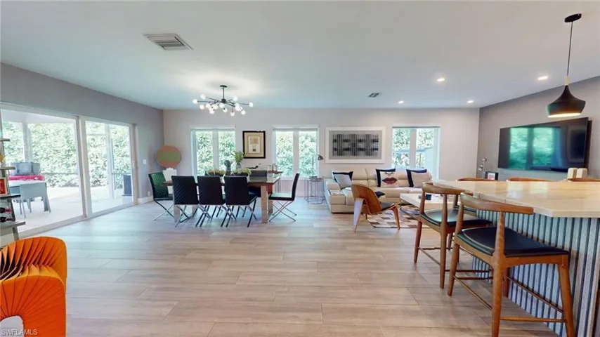 Dining space featuring recessed lighting, light wood finished floors, a chandelier, and visible vents