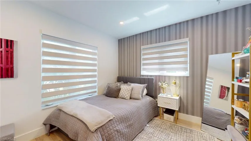 Bedroom featuring wood finished floors and baseboards