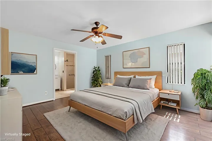Virtually Staged -Bedroom featuring wood-finish flooring, a ceiling fan, light blue wall paint, and vertical blinds on windows