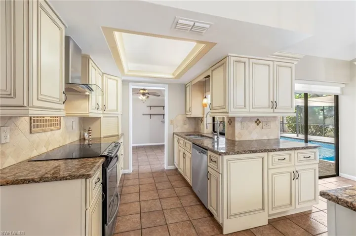 Lovely almond colored cabinetry, granite counter-tops, dome ceiling with custom lighting.