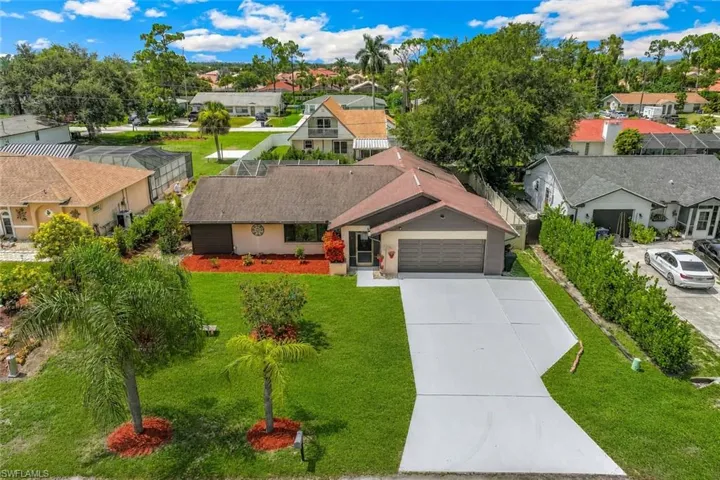 Aerial view - Newly painted driveway, privacy hedge, new mulch, new sod over prior rock area.