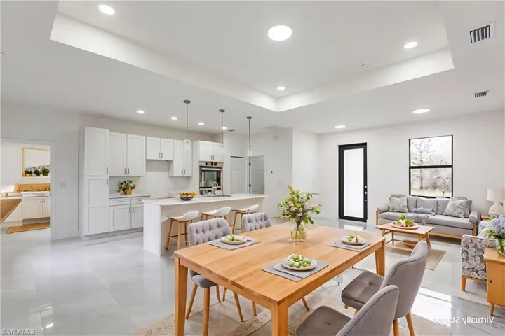 Dining room with a raised ceiling and sink