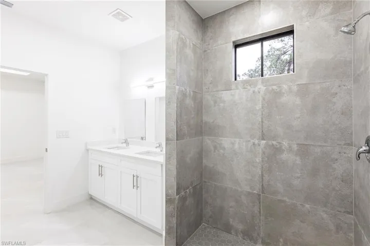 Bathroom with vanity and a tile shower