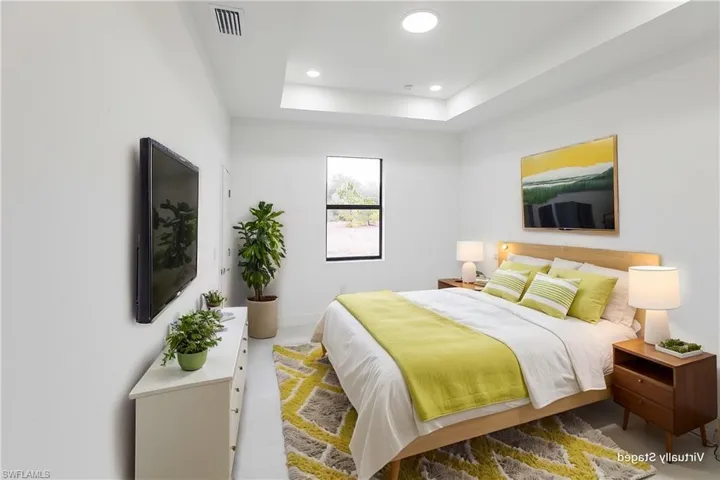 Bedroom featuring a raised ceiling