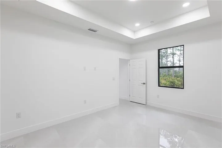 Spare room featuring a tray ceiling