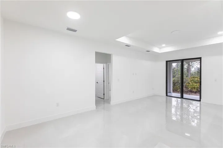 Empty room featuring a raised ceiling