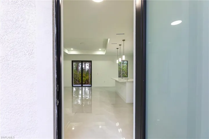 Hall featuring a tray ceiling and sink