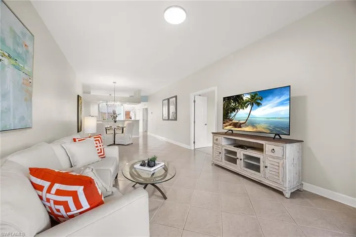 Living area featuring light tile patterned floors and suspended lighting