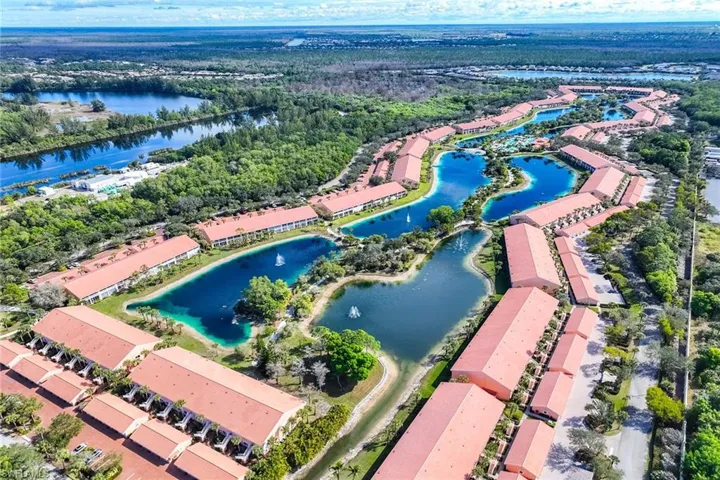 Aerial view of residential area featuring a nearby body of water