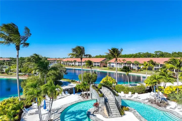 Community pool featuring a water view and a patio area