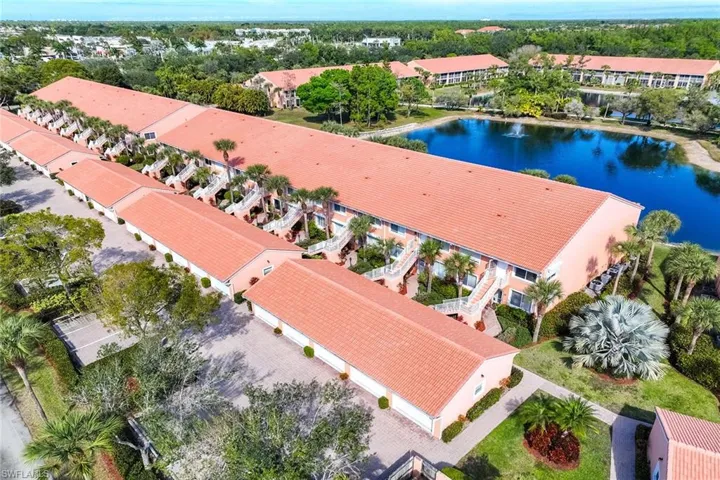 Drone / aerial view of apartment complex and a large body of water