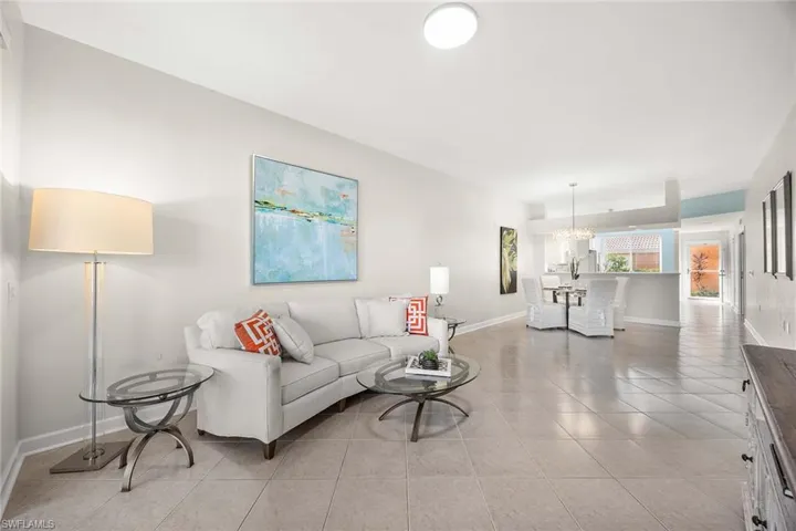 Living room featuring light tile patterned flooring and a chandelier