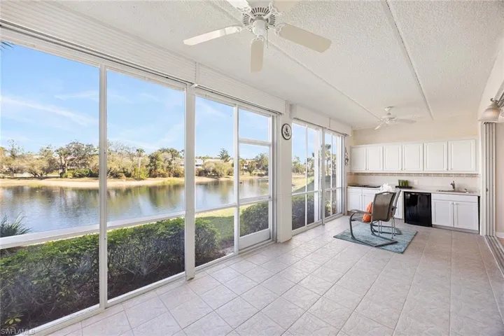 Unfurnished sunroom with a textured ceiling and a water view