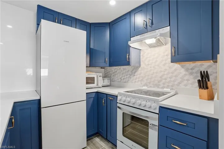 Bosch kitchen features a full quartz accent wall and breakfast bar - Virtually Edited Image