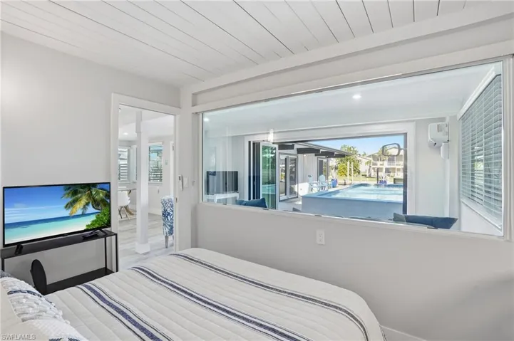 Bedroom featuring pool views - Virtually Edited Image