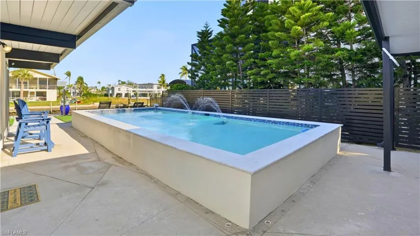 View of swimming pool with a patio area - Virtually Edited Image