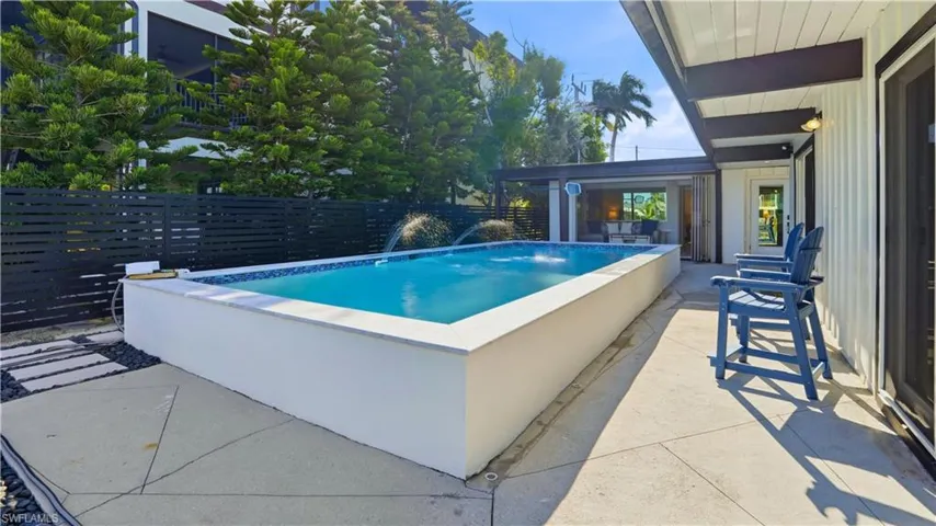View of swimming pool with a patio area - Virtually Edited Image