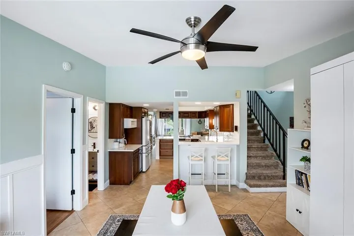 Dining area with light tile patterned floors and a ceiling fan