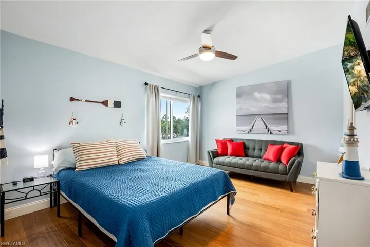 Bedroom with wood finished floors and a ceiling fan