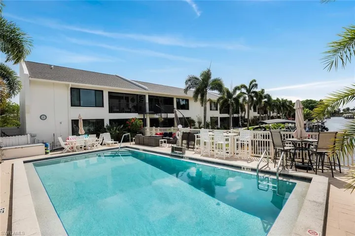 Community pool with a patio area and outdoor lounge area