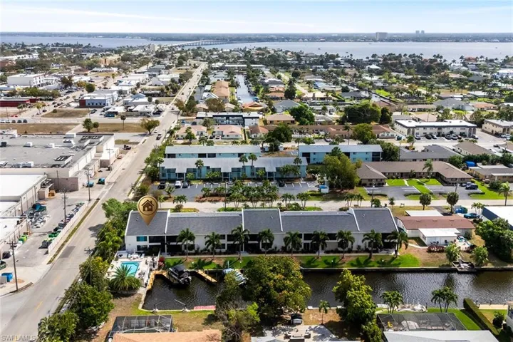 Aerial perspective of suburban area featuring a nearby body of water
