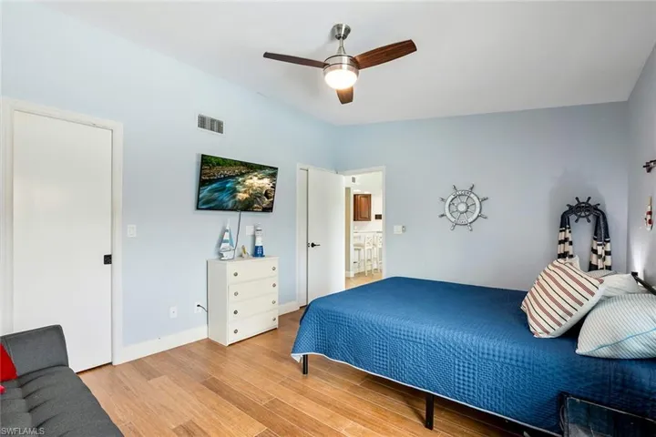 Bedroom with light wood-style floors and ceiling fan