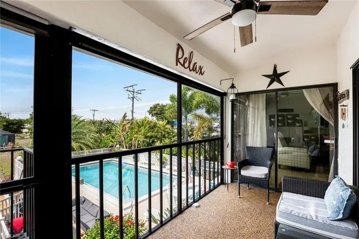 Sunroom with a balcony, ceiling fan, and lofted ceiling