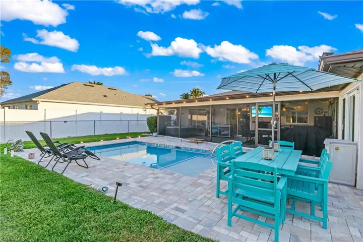 Outdoor oasis with pool, lanai, and fully fenced yard for privacy.