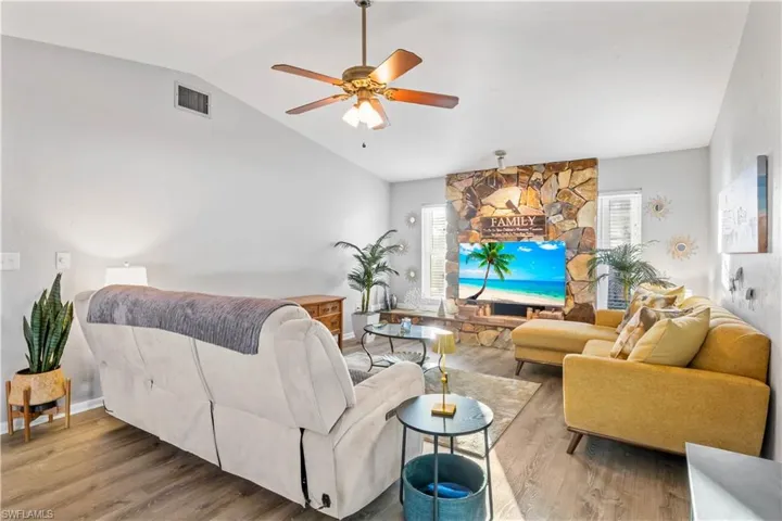 Spacious, light-filled family room featuring a cozy slate fireplace.