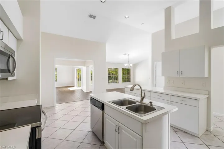Bright kitchen featuring all stainless-steel appliances