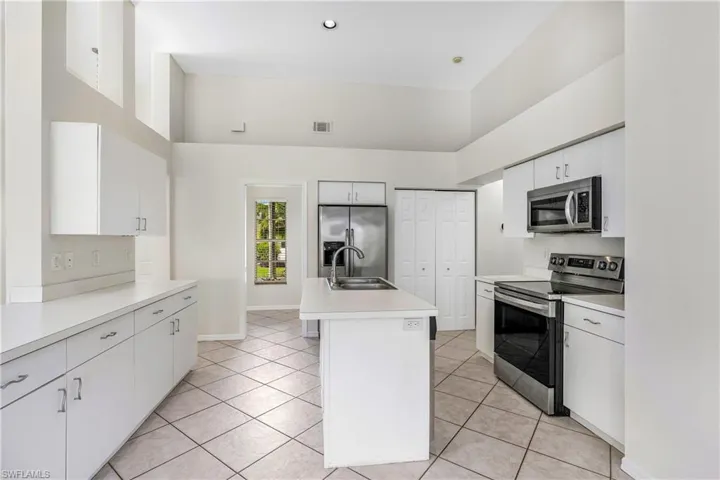 Kitchen featuring white cabinetry and stainless steel appliances