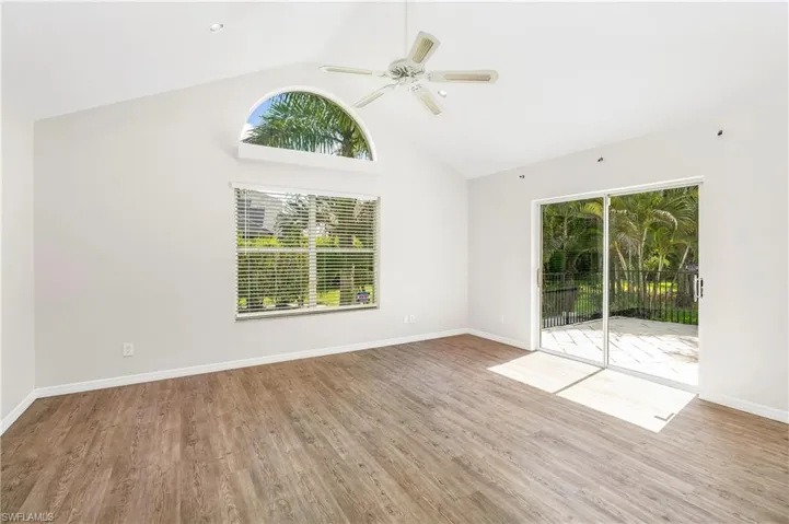 Light - filled living with soaring ceilings and access to the fenced private patio.