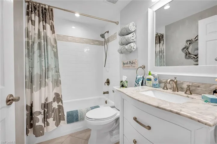 Well-appointed bathroom with a sleek vanity and ample storage space.
