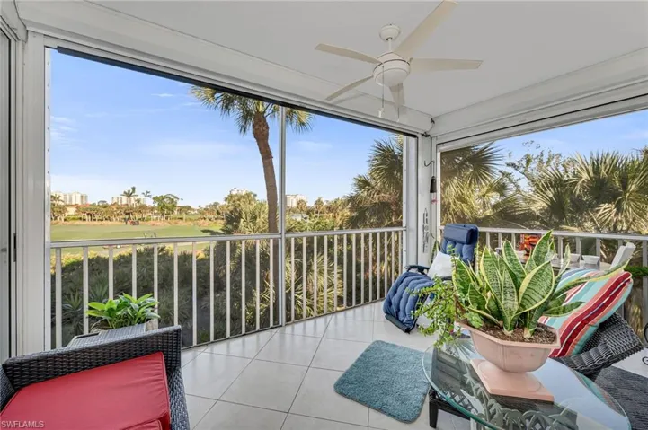 Screened-in lanai with tranquil lake views, ideal for morning coffee or evening relaxation.