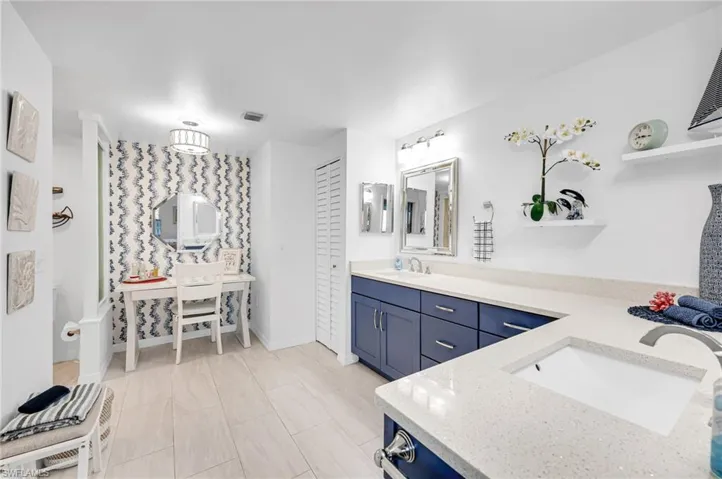Luxurious primary bathroom with elegant finishes, dual vanities, and a spacious walk-in shower.