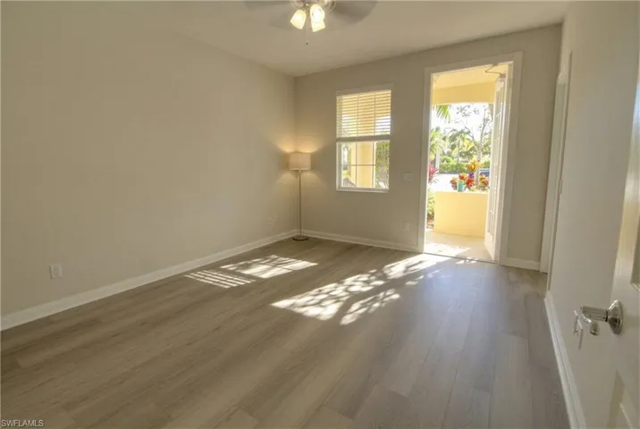Front Bdrm/office downstairs with walk-in closet and balcony