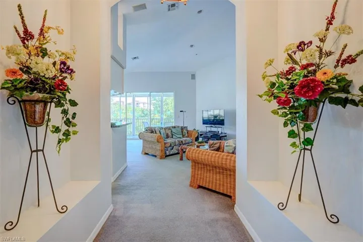Hall with carpet floors and baseboards