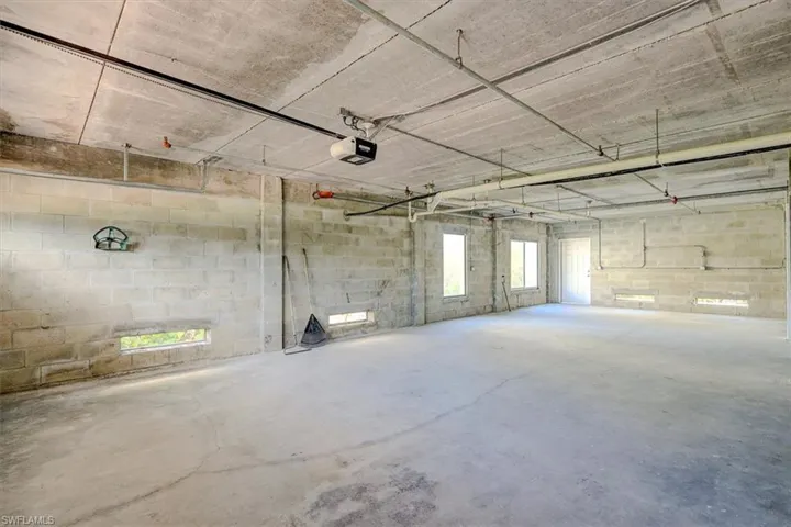 Garage with concrete block wall and a garage door opener