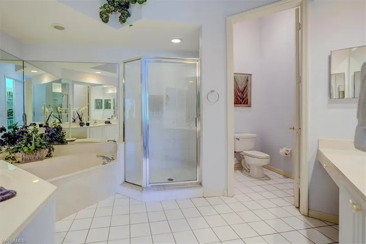 Bathroom with vanity, a shower stall, a bath, tile patterned flooring, and recessed lighting