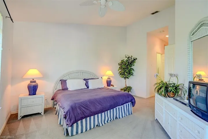 Carpeted bedroom featuring baseboards and ceiling fan