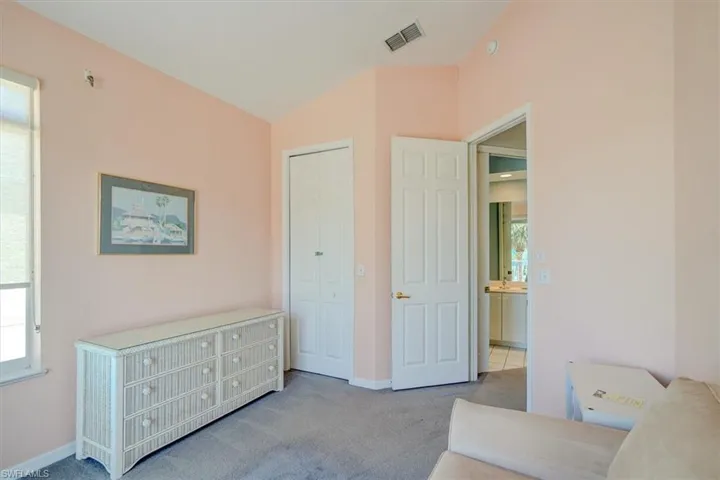 Living area featuring carpet floors and lofted ceiling